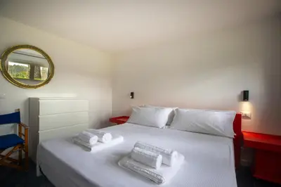 a bedroom with a white bed with towels on it at La casa del Rinoceronte - Scopello, con accesso diretto al mare in Castellammare del Golfo