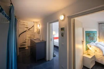 a bedroom with a bed and a room with a mirror at La casa del Rinoceronte - Scopello, con accesso diretto al mare in Castellammare del Golfo