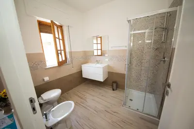 a bathroom with a shower and a toilet and a sink at La Balestra B&B in Balestrate