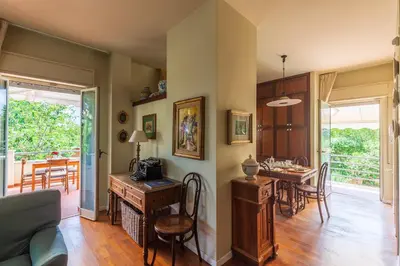a living room with a table and a dining room at Domus Sicily - Villa Conca d'Oro with Pool in Palermo