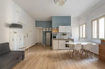 a kitchen and living room with a table and chairs at Sant'Agostino Apartment with Terrace by Wonderful Italy in Palermo