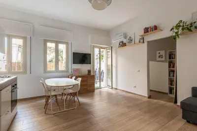 a kitchen and living room with a table and chairs at Sant'Agostino Apartment with Terrace by Wonderful Italy in Palermo