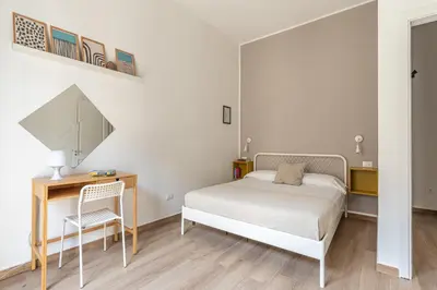 a bedroom with a bed and a desk and a mirror at Sant'Agostino Apartment with Terrace by Wonderful Italy in Palermo