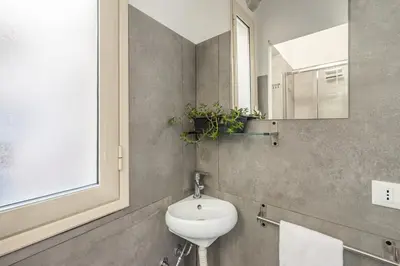 a bathroom with a sink and a mirror at Sant'Agostino Apartment with Terrace by Wonderful Italy in Palermo