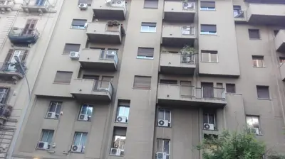 a tall apartment building with windows and balconies at B&B Alexander-Room and Breakfast in Palermo