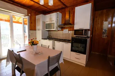 a kitchen with a table with chairs and a counter top at B&B Chiaro di Luna in Corleone