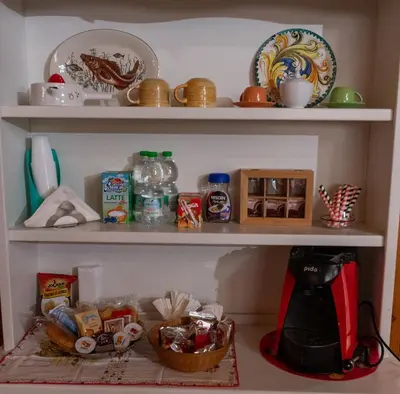 a shelf with food and other items on it at B&B Chiaro di Luna in Corleone