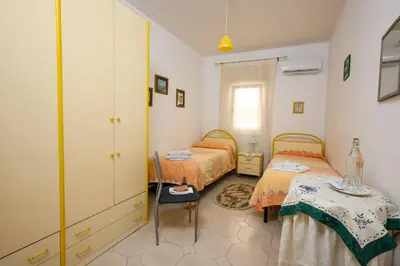 a bedroom with two beds and a table in it at B&B Chiaro di Luna in Corleone