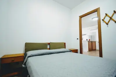 a bedroom with a bed and a mirror at Villa Stella Cinese in Alcamo