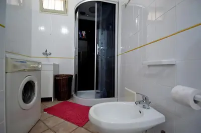 a bathroom with a sink and a washing machine at Villa Stella Cinese in Alcamo