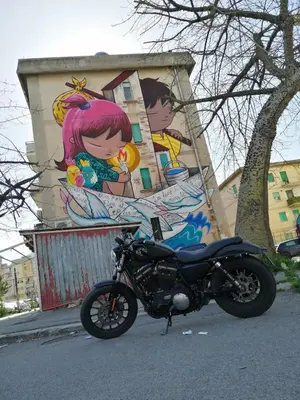 a motorcycle parked on the street in front of a building at Casuzza Ballarò in Palermo