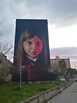 a large painting of a woman on the side of a building at Casuzza Ballarò in Palermo