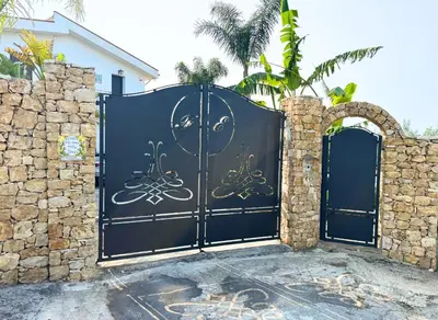 a black gate with a bicycle painted on it at Case Vacanza Zeus in Trappeto