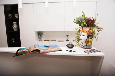 a kitchen counter with a vase with a statue of a woman at Residenza del Castillo in Palermo