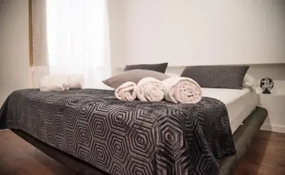 a bedroom with a bed with towels on it at Residenza del Castillo in Palermo