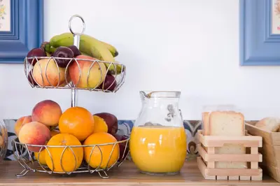 a basket of fruit and a bowl of oranges and apples at Residenza Normanna in Palermo