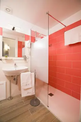 a bathroom with a sink and red tiles at Residenza Normanna in Palermo