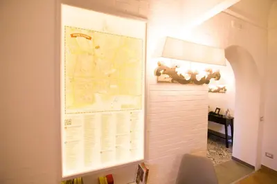 a large map hanging on a wall in a room at Residenza Normanna in Palermo