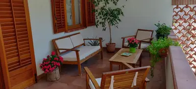 a patio with chairs and a table and a table and chairs at Villetta a due passi dal mare in Palermo