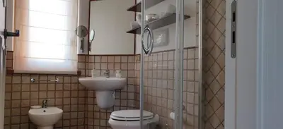 a bathroom with a toilet and a sink at Villetta a due passi dal mare in Palermo