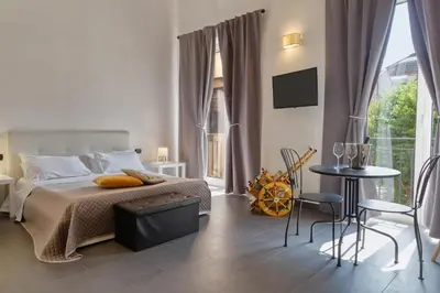 a bedroom with a bed and a table and chairs at Pupi 93 in Palermo