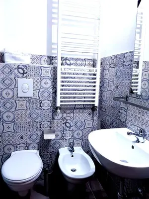 a bathroom with a toilet and a sink at Pupi 93 in Palermo