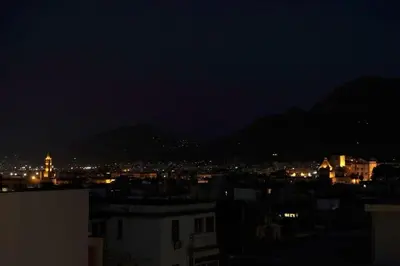 a view of a city at night at THE VIEW in Palermo