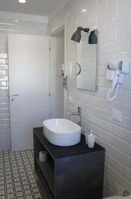 a bathroom with a sink and a mirror at THE VIEW in Palermo