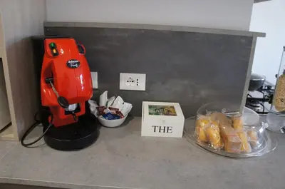 a red blender on a counter next to a bowl of food at THE VIEW in Palermo
