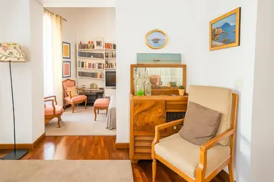 a living room with a desk and a chair at Cassàri Suite in Palermo
