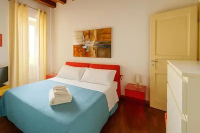 a bedroom with a bed with two towels on it at Cassàri Suite in Palermo