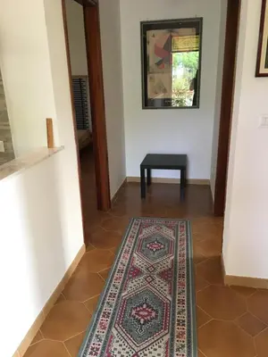 a hallway with a rug on the floor and a table at Villa Augustea in Alcamo