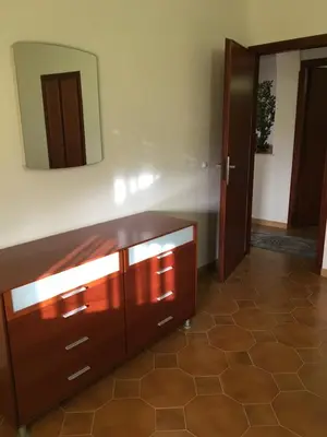 a bathroom with a wooden dresser and a mirror at Villa Augustea in Alcamo