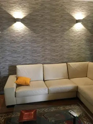 a white couch in a living room with two lights at Villa Augustea in Alcamo