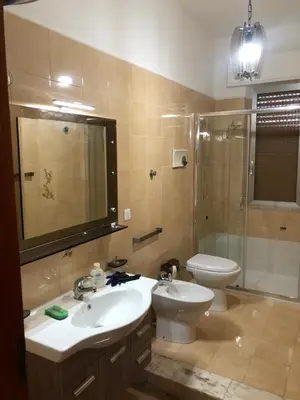 a bathroom with a sink and a toilet and a shower at Villa Augustea in Alcamo
