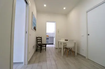 a hallway with a table and chairs in a room at La Casetta di Mondello in Mondello