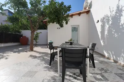a table and chairs in front of a house at La Casetta di Mondello in Mondello