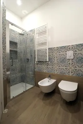 a bathroom with a toilet and a sink and a shower at La Casetta di Mondello in Mondello