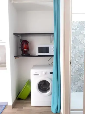 a laundry room with a washing machine and a microwave at Spacious villa with sea and mountain views in Alcamo in Alcamo