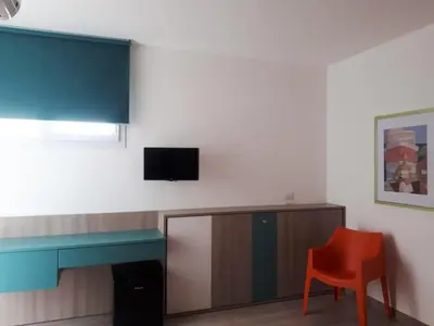 a room with a desk and a red chair at Spacious villa with sea and mountain views in Alcamo in Alcamo