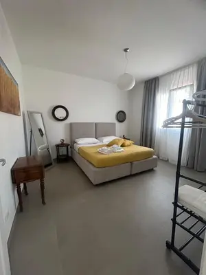 a bedroom with a large bed and a window at Mondello Felix - appartamenti in villa a 600m dal mare in Mondello