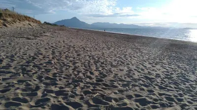 a sandy beach with a view of the ocean at Xenia House in Lascari