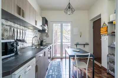 a kitchen with a sink and a table in it at La Maison De Provence - MONDELLO in Mondello