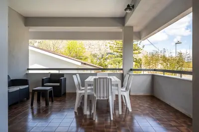 a dining room with a table and chairs on a balcony at La Maison De Provence - MONDELLO in Mondello