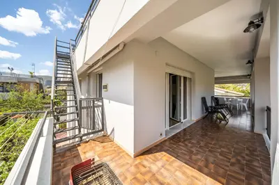 a balcony of a house with a spiral staircase at La Maison De Provence - MONDELLO in Mondello