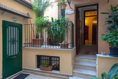 a house with a green door and some plants at ERCTA in Palermo