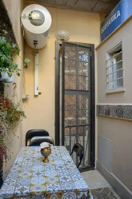 a table and chairs in front of a door at ERCTA in Palermo