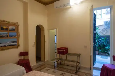 a bedroom with a bed and a door to a courtyard at ERCTA in Palermo