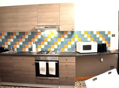 a kitchen with a stove and a microwave at Casa Rosetta in Palermo