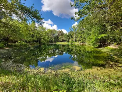 a reflection of the sky in a pond at Chiosi Country Club in Corleone